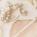 A vintage pearl necklace is a pre-owned string of pearls, typically at least 20-100 years old, prized for its unique character, historical significance, and often superior quality compared to modern counterparts, making it a coveted piece for collectors and fashion connoisseurs alike.